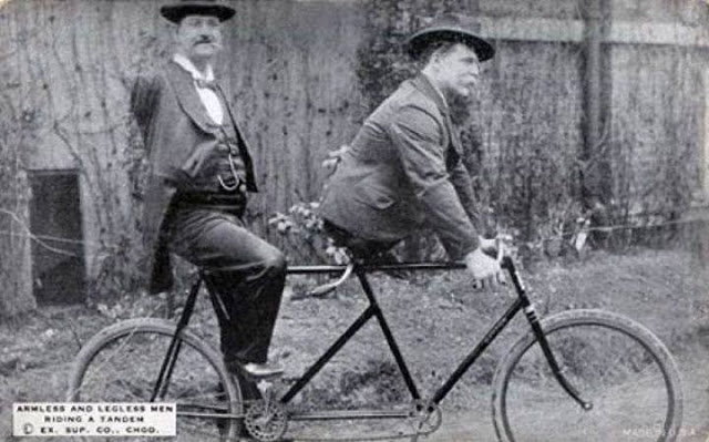 Charles B. Tripp, the armless man and Eli Bowen, the legless man, riding a tandem. 1890s.jpg