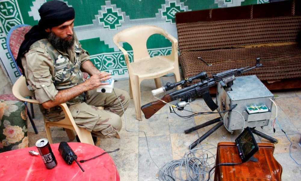 Free Syrian Army fighter tests a remote-controlled weapon REBAL FIGHTER ARMY SOLDIER TROOP.jpg