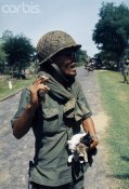 Cambodian soldier with kittens.jpg