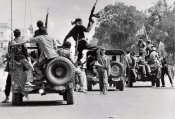 Khmer Rouge guerrillas drive atop jeeps through street Phnom Penh.jpg
