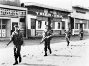 A patrol of Australian ADG moving past abandoned buildings outside the gates of the Phan Rang ai.jpg