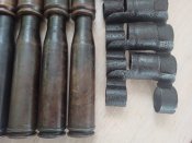10 гильз ВЯ - 23 и 10 звеньев ленты.
