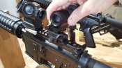 hand-attaching-magnifier-to-rifle.jpg