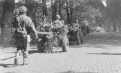 Jeep in the foreground tows a 6-pounder anti-tank gun.jpg